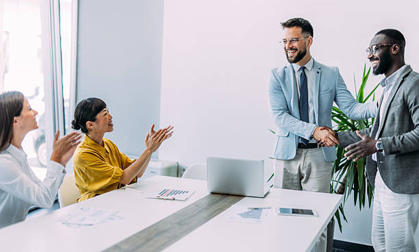 istock Businesspeople shaking hands across the table. 2211649012