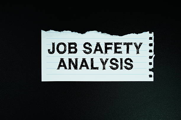 istock Job Safety Analysis text written on paper flat lay on black background 2211649381