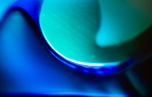 Abstraction of a closeup of a backlit pair of glass vases in a shop window.