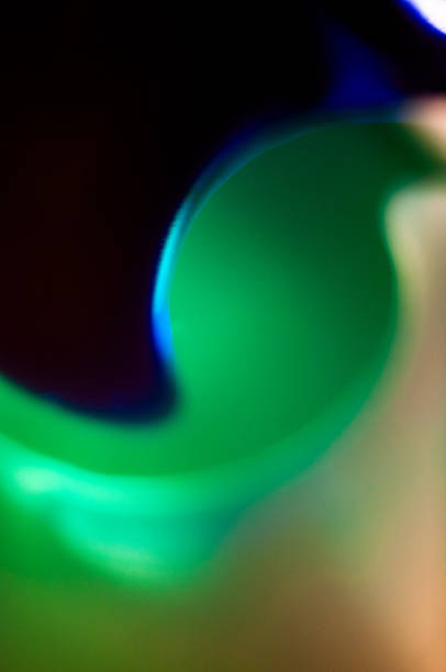 Swirling patterns of green and blue blend together, creating an abstract and colorful display.