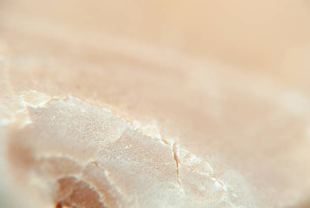 Detailed view of a surface showing unique mineral textures and light reflections.