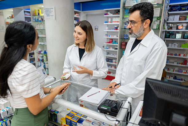 istock Pharmacists talking to a customer athe pharmacy 2211653212