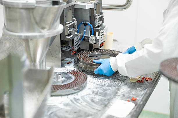 istock Capsule manufacturing equipment in use 2211653343
