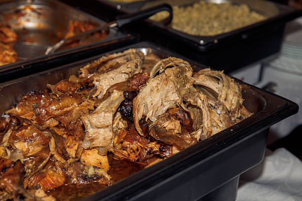 Delicious roast pork ribs served at buffet with cooked vegetables in background, lifestyle