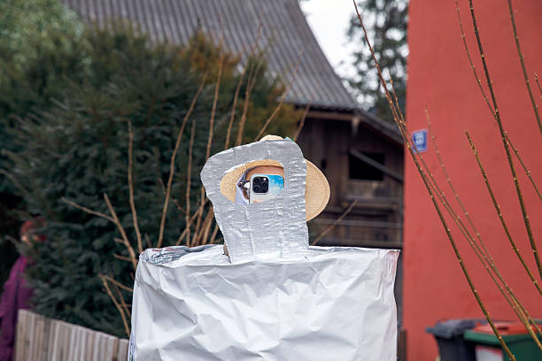 istock Creative robot costume with hat and glasses in outdoor setting 2211658169