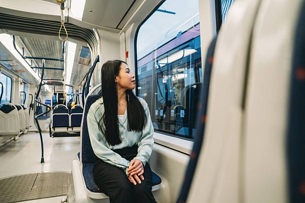 istock Young woman looking through the window while traveling by train 2211658571