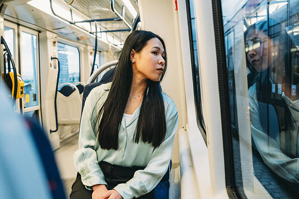 istock Young Woman Looking Out the Window While Riding a Train 2211658590