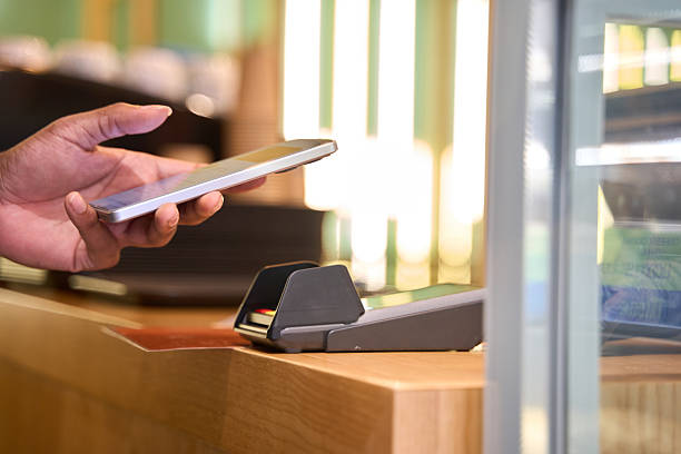 istock Customer paying contactless with smartphone in coffee shop 2211659391
