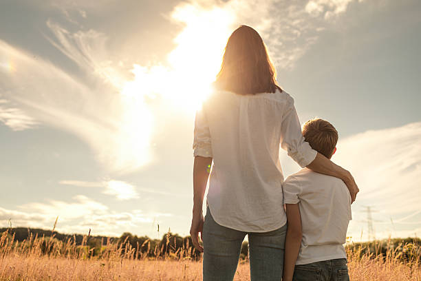 istock Mother and son looking at beautiful sunset. 2211666746