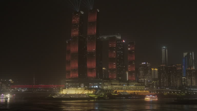 Skyline of Chongqing, China seen from across the river at night. Beautiful modern skyscrapers covered in lights