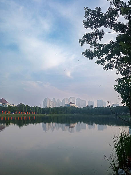 istock Urban Reflections: Surabaya’s Skyscrapers from UNESA Lake View 2211677855