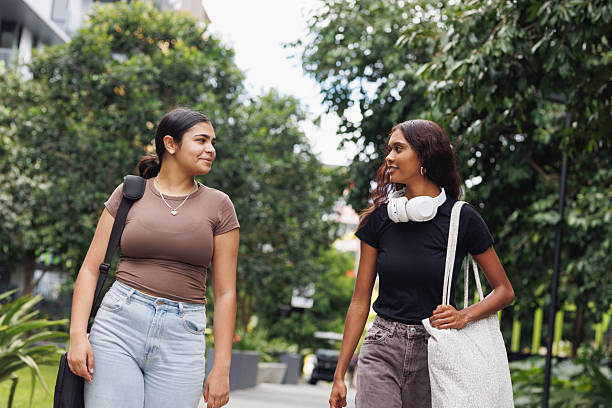 istock Two Aboriginal Australian friends walking through university campus together 2211680489