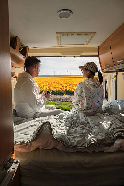 istock Couples retreat in a camper overlooking vibrant tulip fields in Flevoland, Netherlands during spring 2211683655