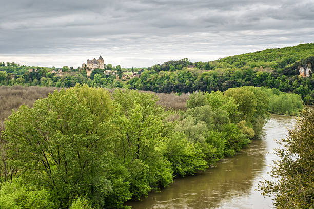 Montfort, Dordogne, France - 22nd April 2025: Chateau de Montfort sits above a swollen and flooded Dordogne river at Montfort in France