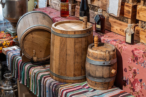 istock Wooden barrels on a bench in a rural interior. 2211688107