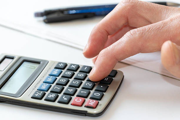 istock Tap the calculator keys with a finger 2211689597