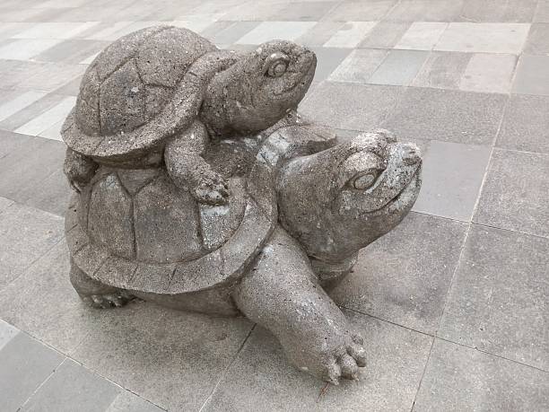 stone statue of a turtle carrying a child