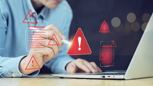 istock Ransomware malware attack and data breach. Businessman using laptop with spam virus on warning caution for notification on internet security protect. 2211695514