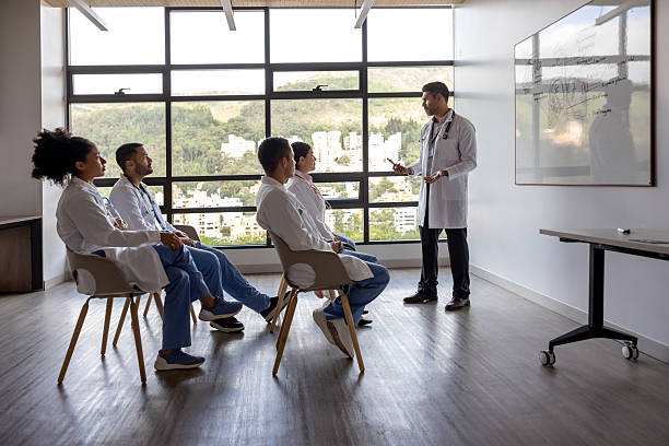istock Doctor teaching a class to a group of medical students 2211699209