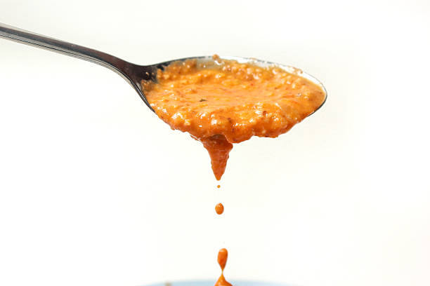 peanut sauce on spoon isolated on white background