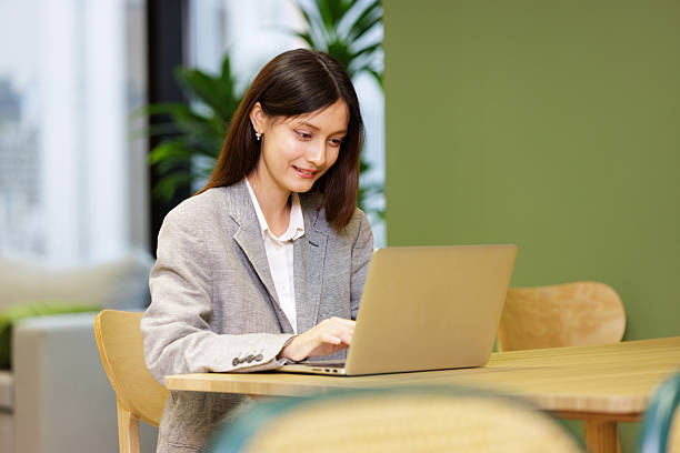 istock Beautiful mix race business woman using computer laptop in modern office 2211699786
