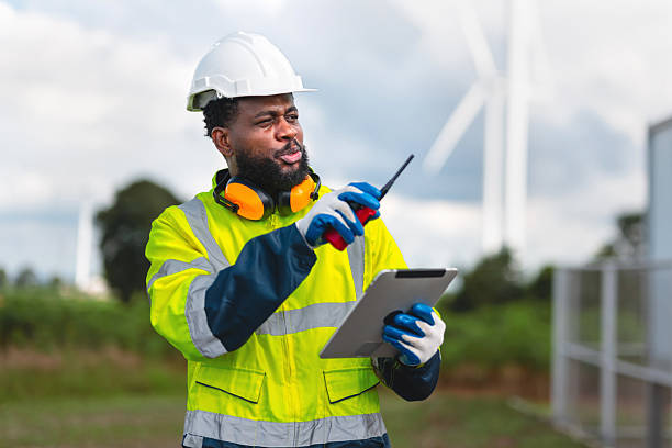istock man in a yellow safety vest is pointing at a tablet while wearing a hard hat 2211702387