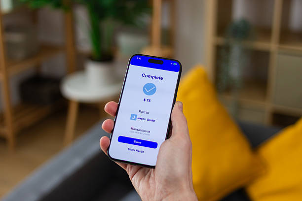 istock Person holding smartphone showing successful mobile payment confirmation screen 2211704885