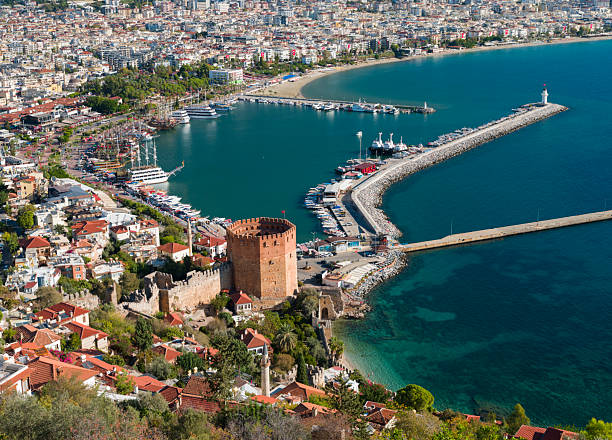 Red view of the Red Tower ( Kizilkule ) and Alanya harbour from the walls of Alanya castle. Mediterranean coast. Tourist symbols of Antalya. Country of Turkey