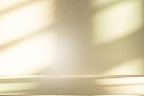 istock Studio style background wall decoration presentation uses white and beige tones. with shadows cast from a nearby window, concept creating a decorative 2211707547