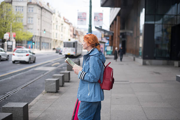 istock Female tourist taking a break and exploring the city map 2211709069