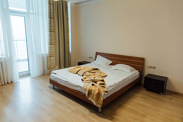 istock Empty white bed with linen in the bedroom in the morning 2211710656
