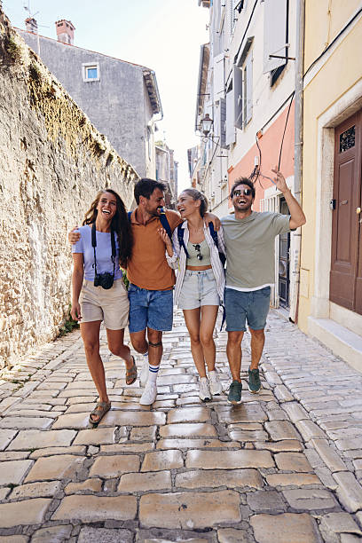 istock Cheerful tourists having fun while walking on the street. 2211711814