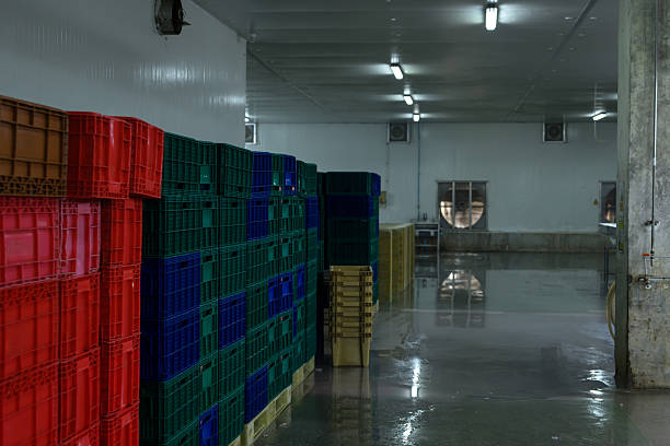istock Stacks of plastic crates arranged in a food processing plant storage area. 2211711847