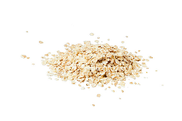 istock pile of oat flakes isolated on white 2211715275