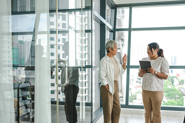 istock Women of Different Ethnicities Work Together in Modern Office 2211715378
