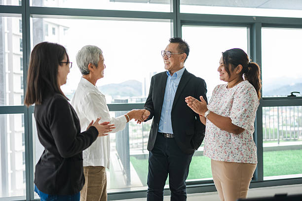 istock Forging Partnerships: Businesspeople Shake Hands in a Modern Office Setting stock photo 2211715816
