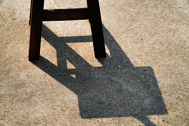 Shadow of chair on cement floor