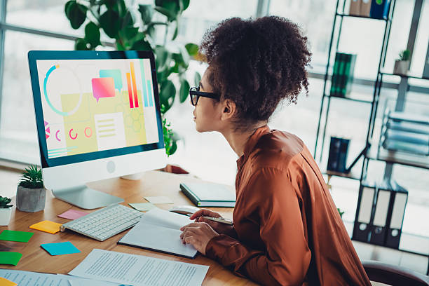 istock Young female professional reviewing data on a computer in a modern office workspace during a productive workday 2211717418