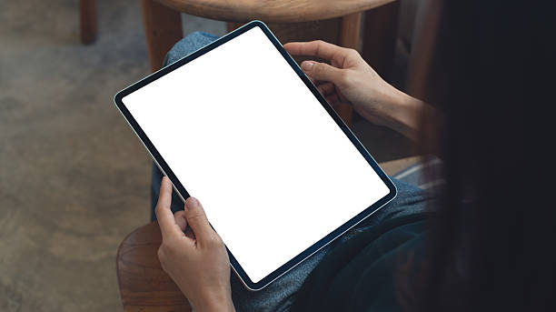 istock Mockup image of woman using digital tablet with blank white screen during working at coffee shop, close up. Mockup tablet for online marketing or web template 2211719292