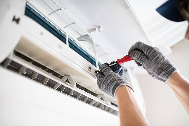 istock Technician with screwdriver repairing air conditioner at home 2211719478