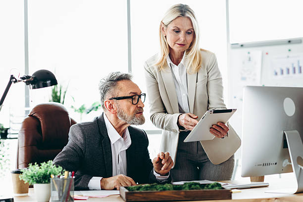istock Professional colleagues discussing business strategies in a modern workspace with collaborative team effort 2211719767