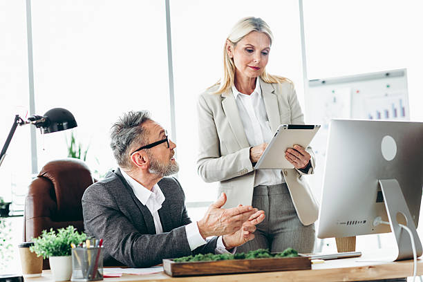 istock Professional colleagues collaborating in a modern office setting, discussing business strategies and ideas during a productive meeting 2211719771