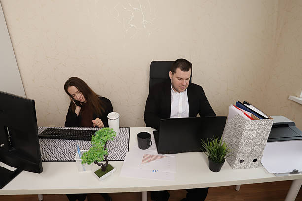 istock Focused Business Colleagues Discussing Project Data on Laptop and Printed Charts 2211722136