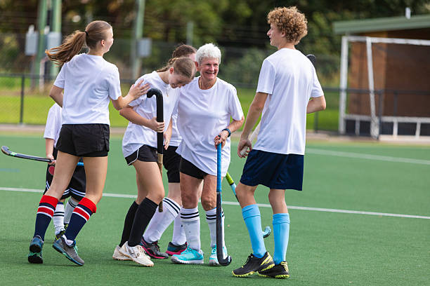 istock Field hockey team celebrating scoring a goal 2211723253