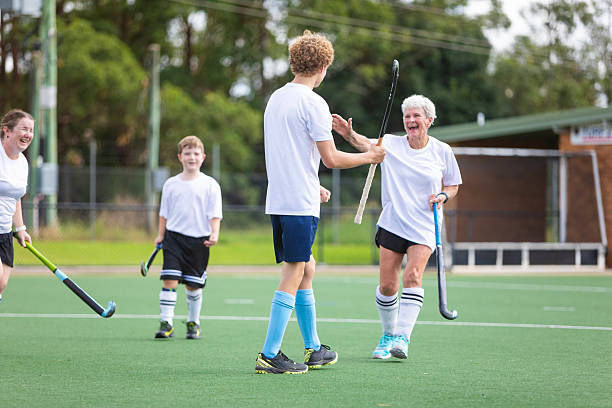istock Field hockey team celebrating scoring a goal 2211723268