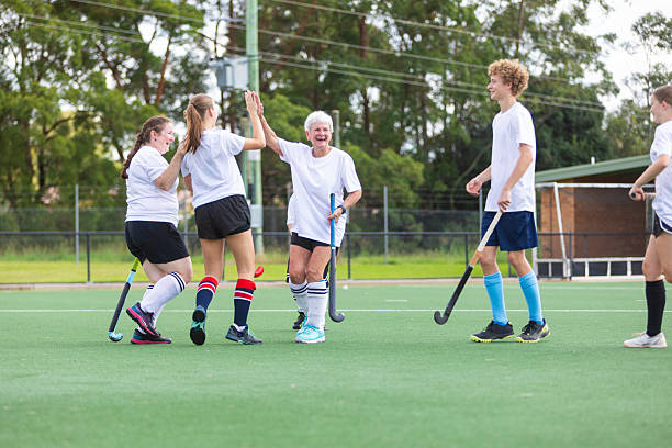 istock Field hockey team celebrating scoring a goal 2211723269