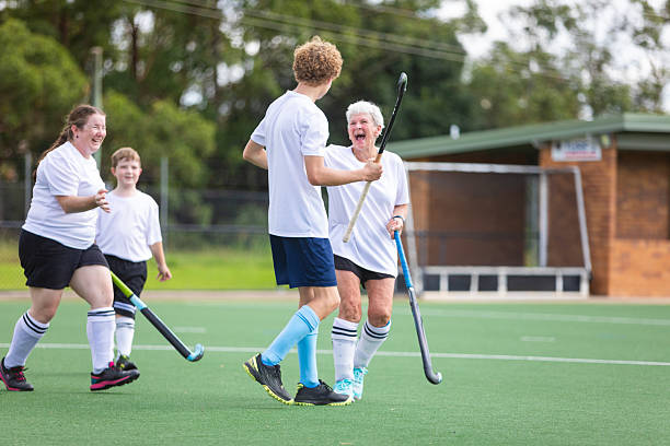 Field hockey team celebrating scoring a goal