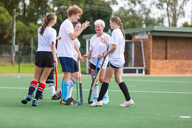 istock Field hockey team celebrating scoring a goal 2211723279