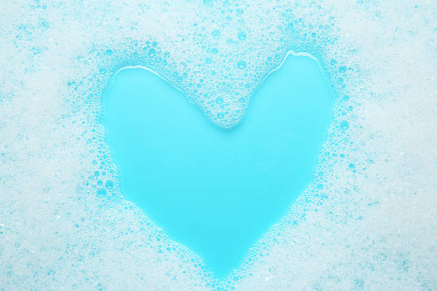istock Washing laundry. White foam with bubbles on light blue background, top view 2211723305
