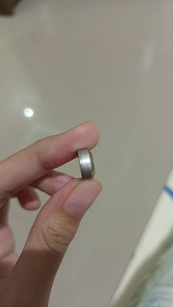 istock holding the clock battery with your finger 2211723382